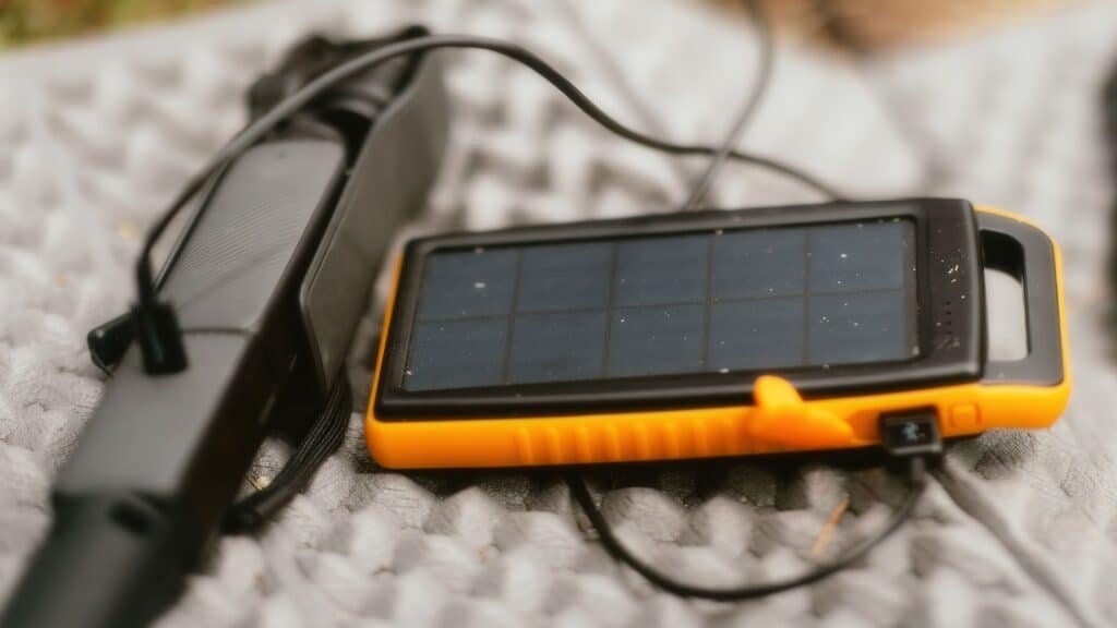 A solar powered device is laying on a blanket